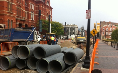 New sewer pipes arrive for installation.